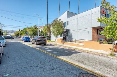 an empty street with cars parked on the side of a building at La Mirage Inn - Hollywood in Los Angeles