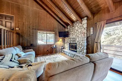 a living room with couches and a fireplace at Grey Stone Fire in Running Springs