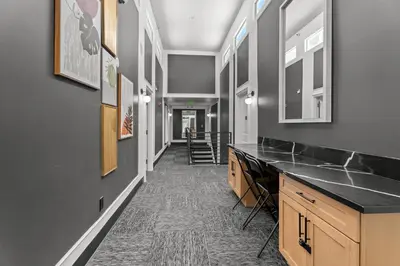 a hallway with a counter and a hallway with stairs at Hollywood Le Bon Hotel in Los Angeles