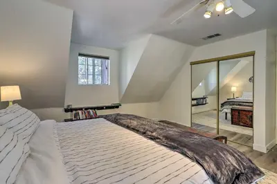 a bedroom with a large bed and a mirror at Cozy Cabin about 3 Mi to Lake Arrowhead Village! in Lake Arrowhead