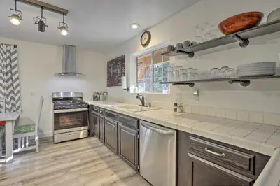 a kitchen with a sink and a counter top at Cozy Cabin about 3 Mi to Lake Arrowhead Village! in Lake Arrowhead