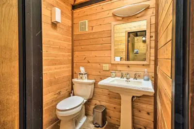 a bathroom with a toilet and a sink at Cozy Grand Woodland Cabin with Mountain Views in Pine Mountain Club
