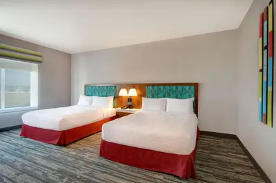 a hotel room with two beds and a window at Hampton Inn & Suites By Hilton Rancho Cucamonga in Rancho Cucamonga