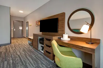 a room with a desk with a television and a mirror at Hampton Inn & Suites By Hilton Rancho Cucamonga in Rancho Cucamonga