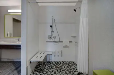 a bathroom with a bench and a sink and a shower at Hampton Inn & Suites By Hilton Rancho Cucamonga in Rancho Cucamonga