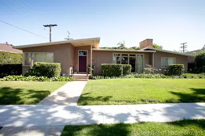 a house with a green lawn in front of it at Bixby Beauty 50s Mod Long Beach in Long Beach