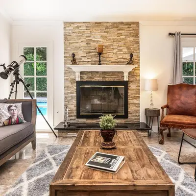 a living room with a fireplace and a coffee table at Villa Sausalito - Newly Designed 4BR HOUSE & POOL by Topanga in Los Angeles