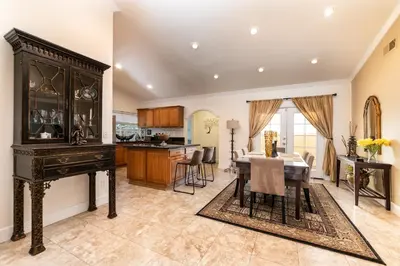 a kitchen and dining room with a table and a dining room at Villa Sausalito - Newly Designed 4BR HOUSE & POOL by Topanga in Los Angeles