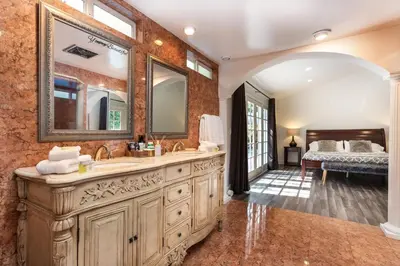 a bathroom with a sink and a mirror at Villa Sausalito - Newly Designed 4BR HOUSE & POOL by Topanga in Los Angeles