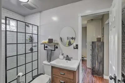a white bathroom with a sink and a shower at Charming Craftsman Bungalow with Garden and Hot Tub! in Fullerton