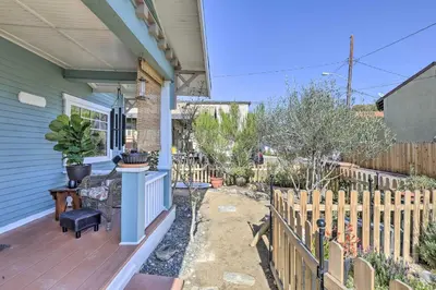 a porch of a house with a wooden fence at Charming Craftsman Bungalow with Garden and Hot Tub! in Fullerton