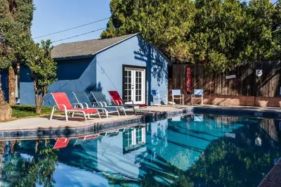 a swimming pool with chairs and a house at Le Bleu House - Newly Designed 3BR HOUSE & POOL by Topanga in Los Angeles