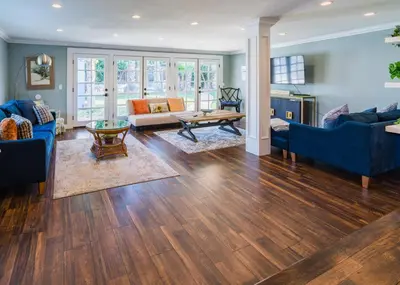 a living room with blue furniture and wooden floors at Le Bleu House - Newly Designed 3BR HOUSE & POOL by Topanga in Los Angeles