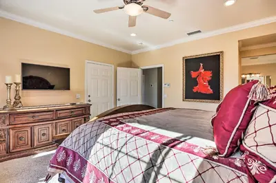 a bedroom with a bed and a dresser and a tv at Huge Lake Arrowhead Home with 3 Decks and Grill! in Lake Arrowhead