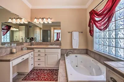 a large bathroom with a tub and a large mirror at Huge Lake Arrowhead Home with 3 Decks and Grill! in Lake Arrowhead