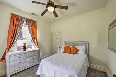 a bedroom with a bed and a ceiling fan at Riverside House with Yard about 1 Mi to Downtown! in Riverside