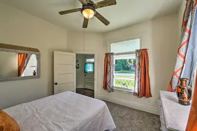 a bedroom with a bed and a ceiling fan at Riverside House with Yard about 1 Mi to Downtown! in Riverside