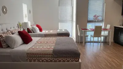a bedroom with two beds and a dining room with a table at Incredible Hollywood Loft Free Parking in Los Angeles