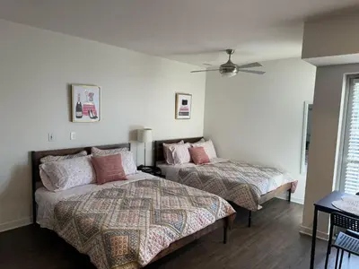 a bedroom with two beds and a ceiling fan at Incredible Hollywood Loft Free Parking in Los Angeles