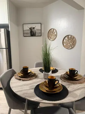 a dining room table with chairs and a cow on the wall at Hollywood Prime Location Walk to Hollywood Attractions Free Parking in Los Angeles