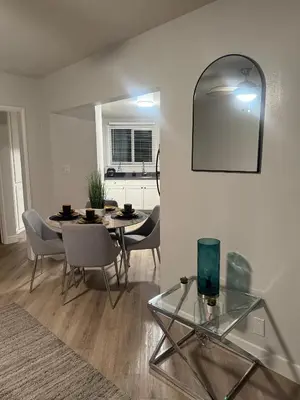 a dining room with a table and chairs and a mirror at Hollywood Prime Location Walk to Hollywood Attractions Free Parking in Los Angeles