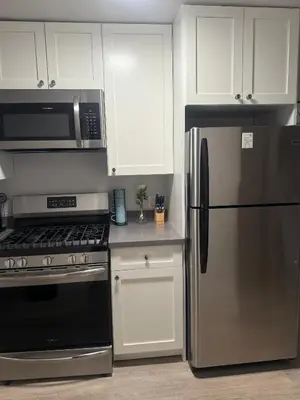 a kitchen with stainless steel appliances and white cabinets at Hollywood Prime Location Walk to Hollywood Attractions Free Parking in Los Angeles