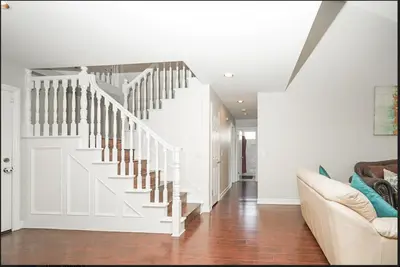 a white staircase in a living room with a couch at Valencia CA Stunning 3100 +sqft, 5Bed/5Bath home in Santa Clarita