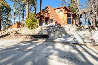 a house on a hill in the woods at The Valley's Cabin in Green Valley Lake