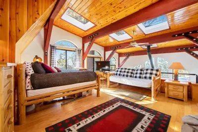 a living room with a couch and a tv at The Valley's Cabin in Green Valley Lake