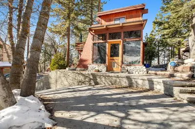 a home in the woods with a small building at The Valley's Cabin in Green Valley Lake