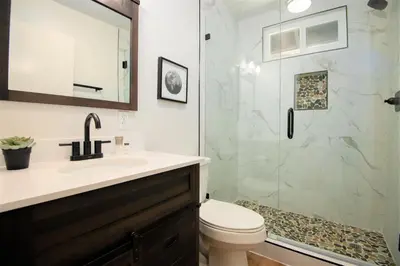 a bathroom with a shower and a toilet and a sink at Sequoia Trails, mountains, fun & relax in Ponderosa
