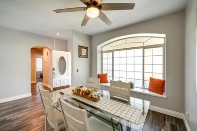 a dining room with a table and chairs and a ceiling fan at Private Pool and Patio Pet-Friendly Bakersfield Gem in Bakersfield
