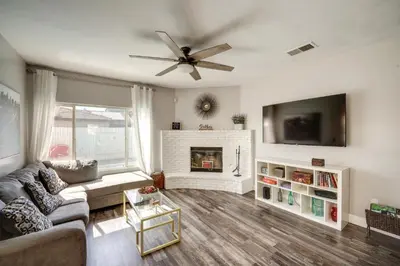 a living room with a couch and a fireplace at Private Pool and Patio Pet-Friendly Bakersfield Gem in Bakersfield
