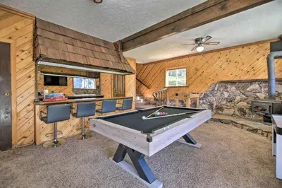 a pool table in a room with wooden walls at Luxe Escape with Decks, Mtn Views, Game Room! in Frazier Park