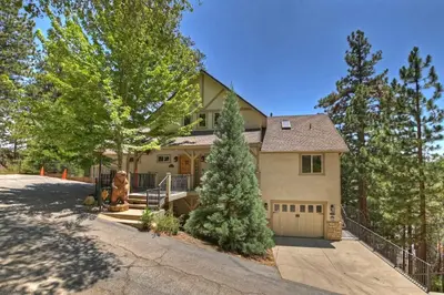 a house with a gate and a driveway at Beautiful Lake Arrowhead Cabin with EV Charger in Lake Arrowhead