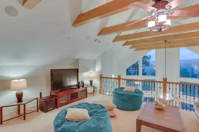 a living room with a couch and a tv at Beautiful Lake Arrowhead Cabin with EV Charger in Lake Arrowhead