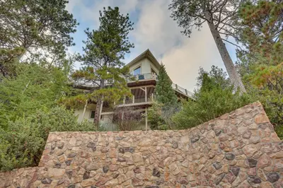 an image of a house with a stone wall at Beautiful Lake Arrowhead Cabin with EV Charger in Lake Arrowhead
