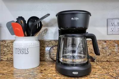 a coffee maker sitting next to a container of utensils at Dreamy & Relaxing Gem With Backyard - 12mins to DT LA in Alhambra