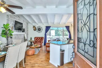 a kitchen and living room with a table and chairs at Lake house Cabin - Lake Arrowhead in Lake Arrowhead