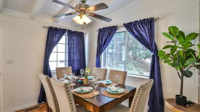 a dining room with a table and a ceiling fan at Lake house Cabin - Lake Arrowhead in Lake Arrowhead