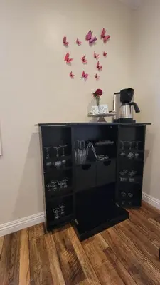 a black cabinet with pink butterflies on the wall at Adorable modern guesthouse with full kitchen in Encino