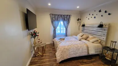 a bedroom with a large bed and a window at Adorable modern guesthouse with full kitchen in Encino