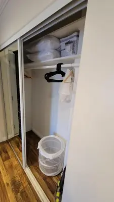 an empty closet with a door open and a bucket in a room at Adorable modern guesthouse with full kitchen in Encino