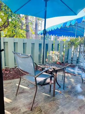a chair and a table with an umbrella on a patio at Foghorn Harbor Inn in Los Angeles