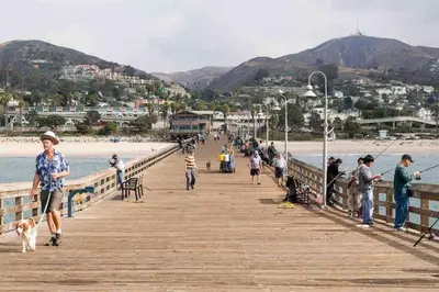 a group of people walking on a pier with a dog at Beautiful and Cozy 4-BR residential home!!! in Oxnard