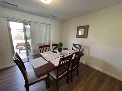a dining room with a wooden table and chairs at Beautiful and Cozy 4-BR residential home!!! in Oxnard
