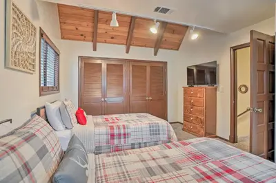 a bedroom with two beds and a dresser at Woodsy Twin Peaks Getaway with Hot Tub and Views! in Twin Peaks