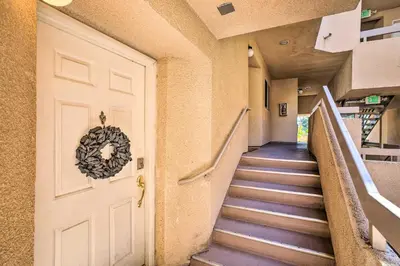 a hallway with a white door and stairs at 2 Mi to Griffith Park! Burbank Extended-Stay Condo in Burbank
