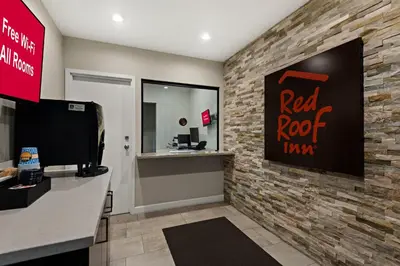a red roof office with a brick wall at Red Roof Inn Carson - Wilmington, CA in Wilmington