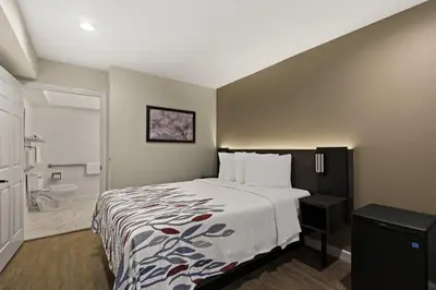 a hotel room with a bed and a bathroom at Red Roof Inn Carson - Wilmington, CA in Wilmington